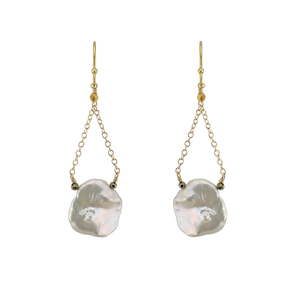 Pair of earrings with large, irregularly shaped pearls on gold chains against a white background.