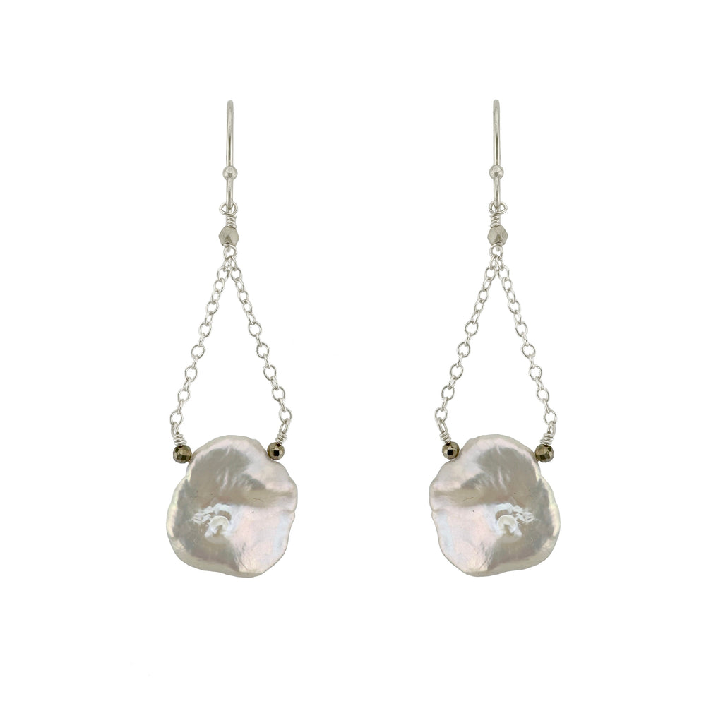 Pair of earrings with large, irregularly shaped pearls on a white background