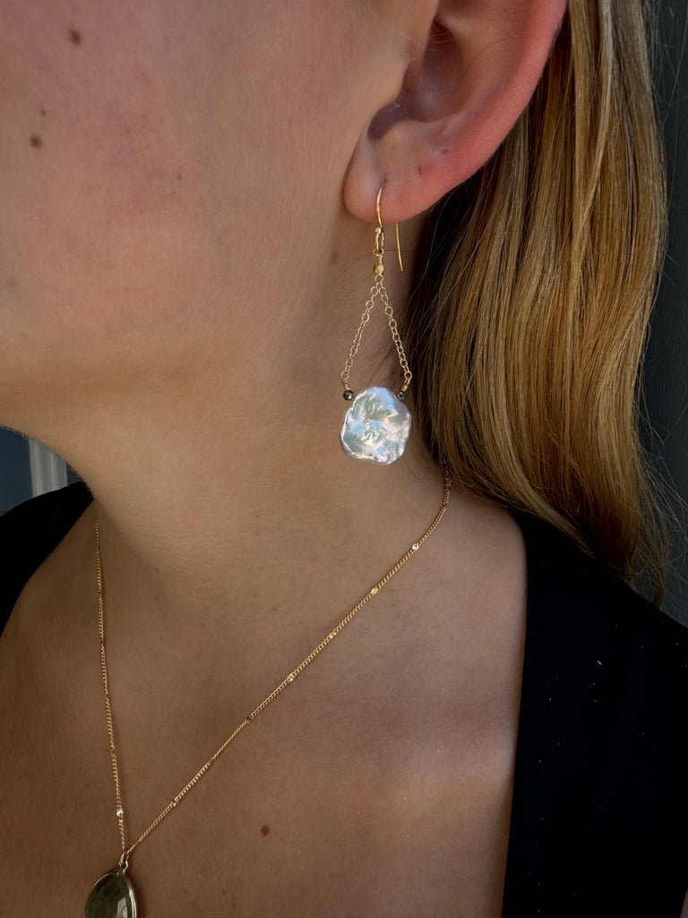 hanging pearl earrings on the ear