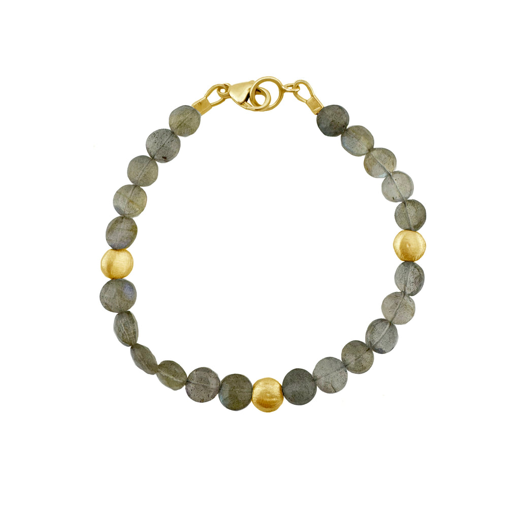 Bracelet with gray labradorite and gold beads on a white background