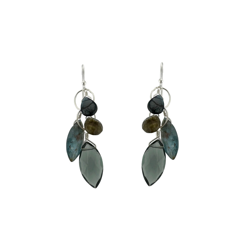 Pair of earrings with green and black stone drops on a white background