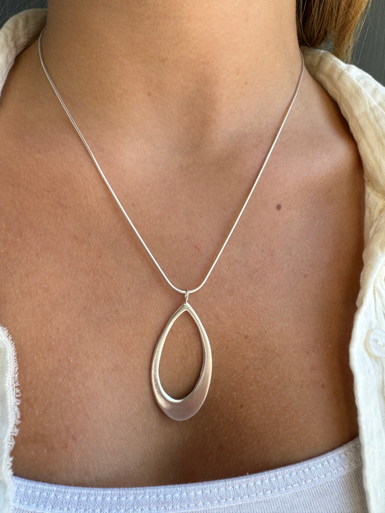 large leaf necklace on persons neck