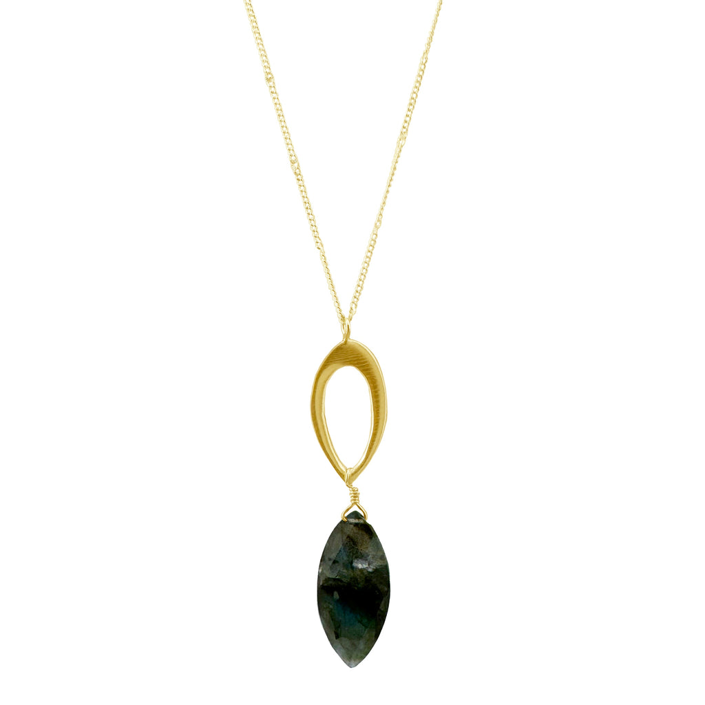 Gold necklace with a green gemstone pendant on a white background