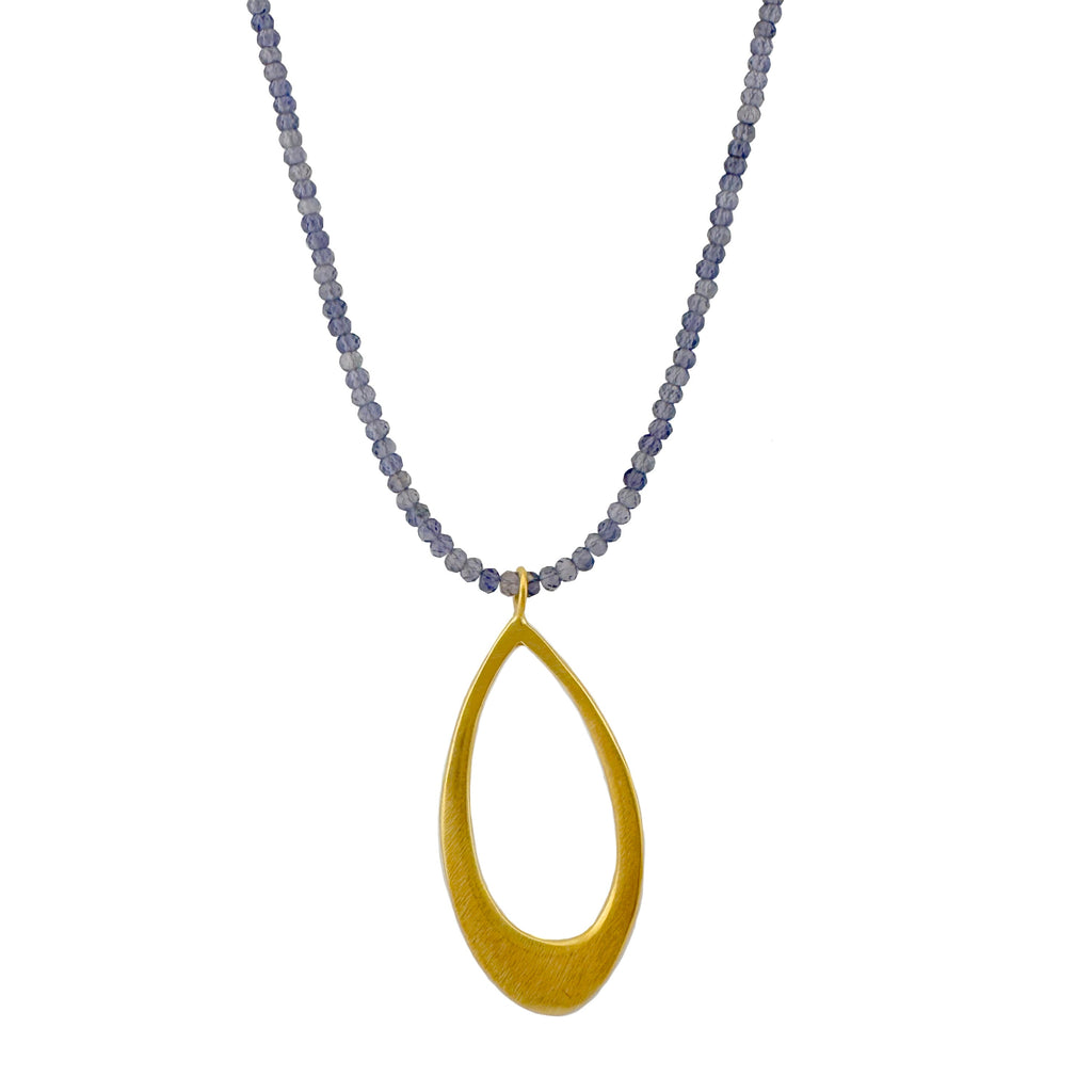 Necklace with a gold teardrop pendant and iolite beads on a white background