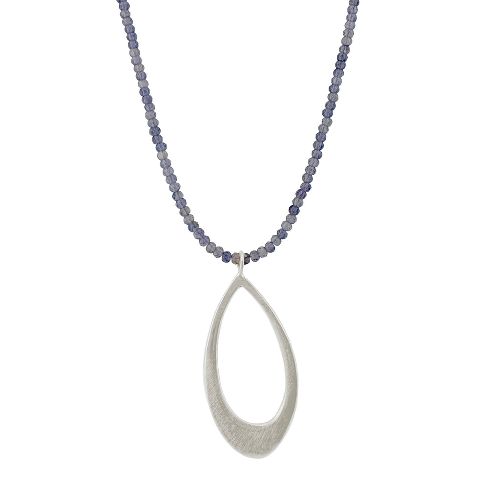 Necklace with a silver teardrop pendant with iolite on a white background