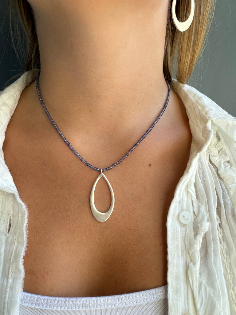 medium leaf on iolite beads necklace on persons neck