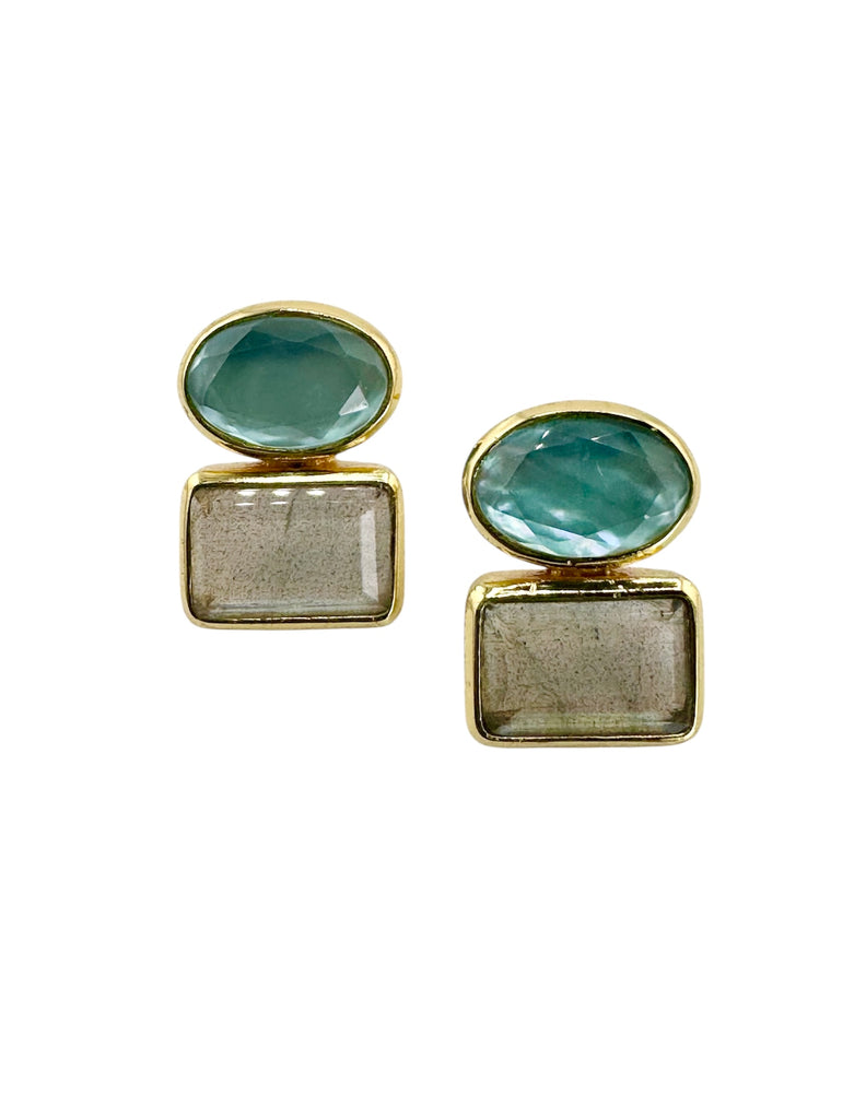 Pair of earrings with green gemstones and gold accents on a white background