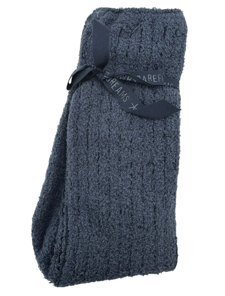 Folded blue socks with brand label on a white background