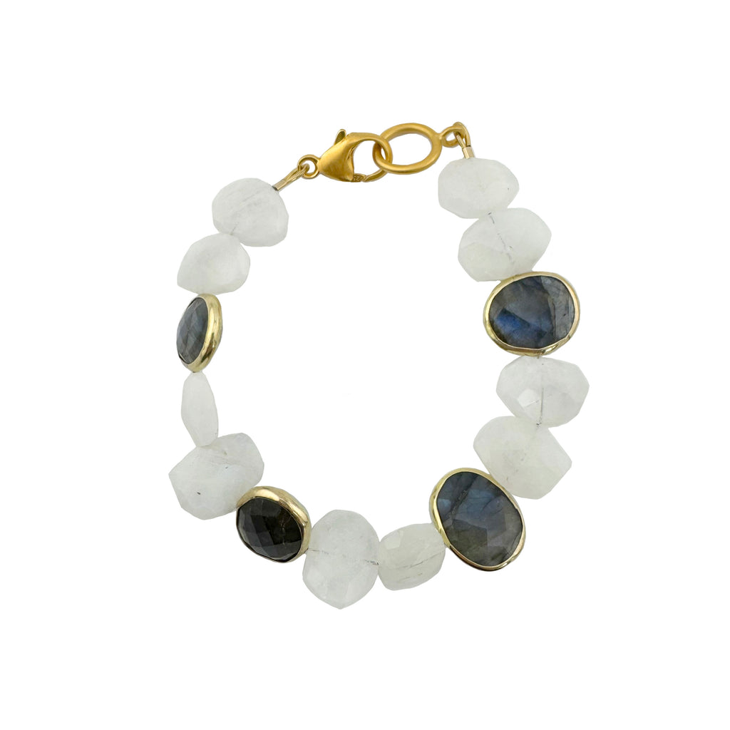 Bracelet with white beads and blue gemstones on a white background