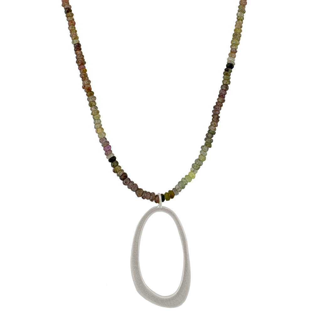 Necklace with multicolored beads and a large silver pendant on a white background