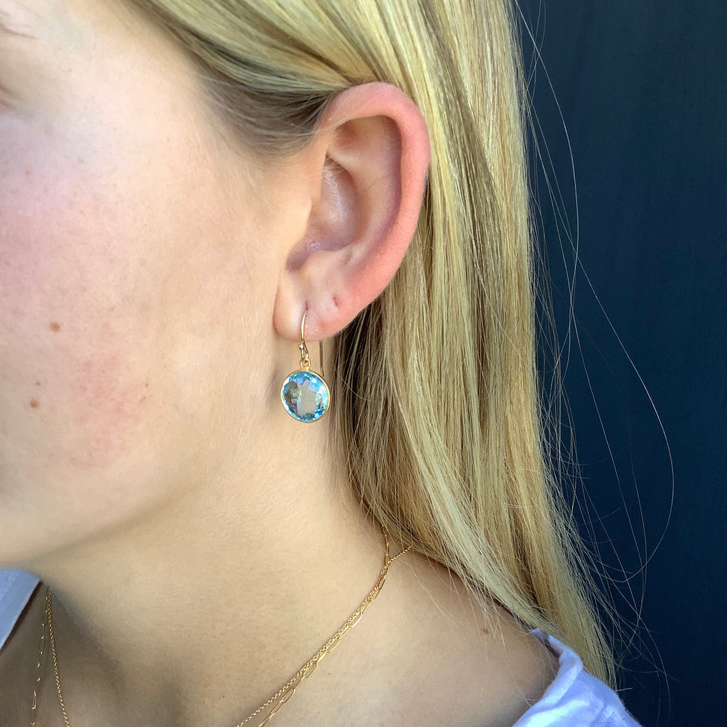 round swiss blue topaz earrings in gold vermeil on the ear