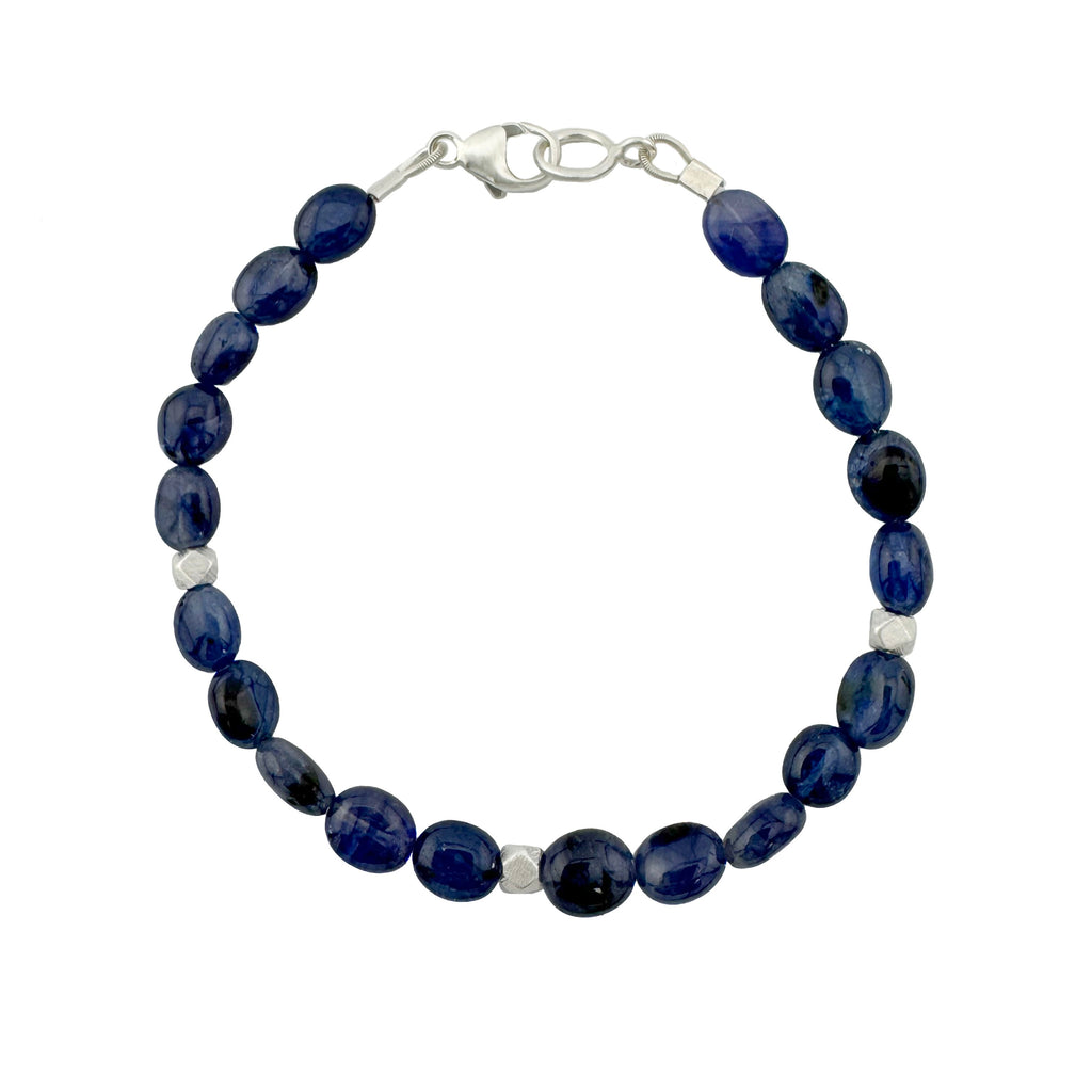 Navy blue beaded bracelet with silver clasp on a white background