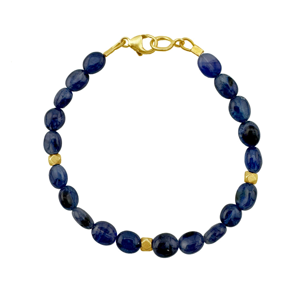 Navy blue beaded bracelet with gold accents on a white background