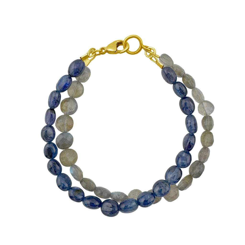 Beaded bracelet with blue and gray stones and a gold clasp on a white background
