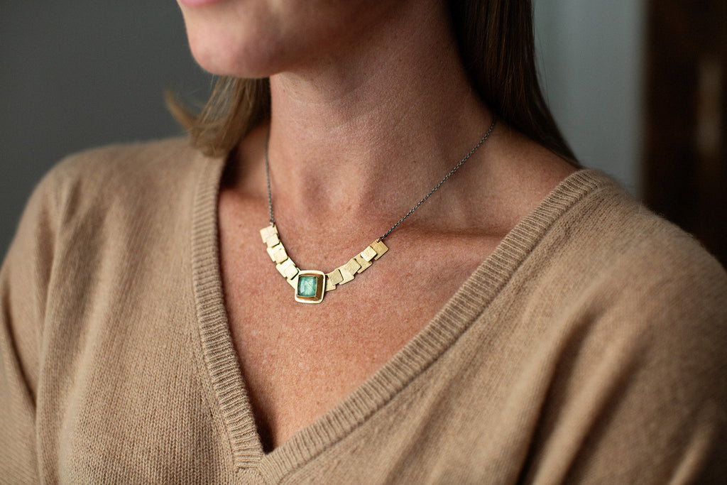 square pivot necklace on a model