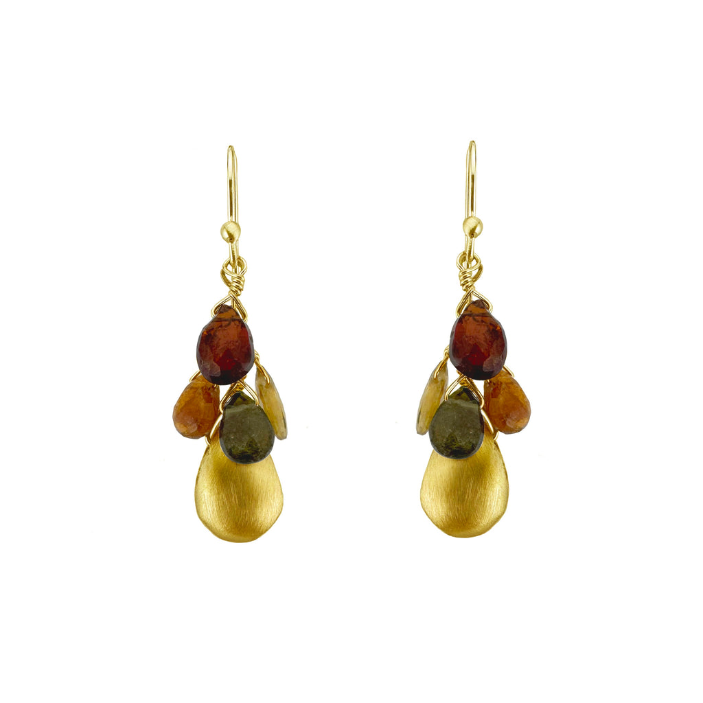 Gold earrings with amber and greenstone stones on a white background