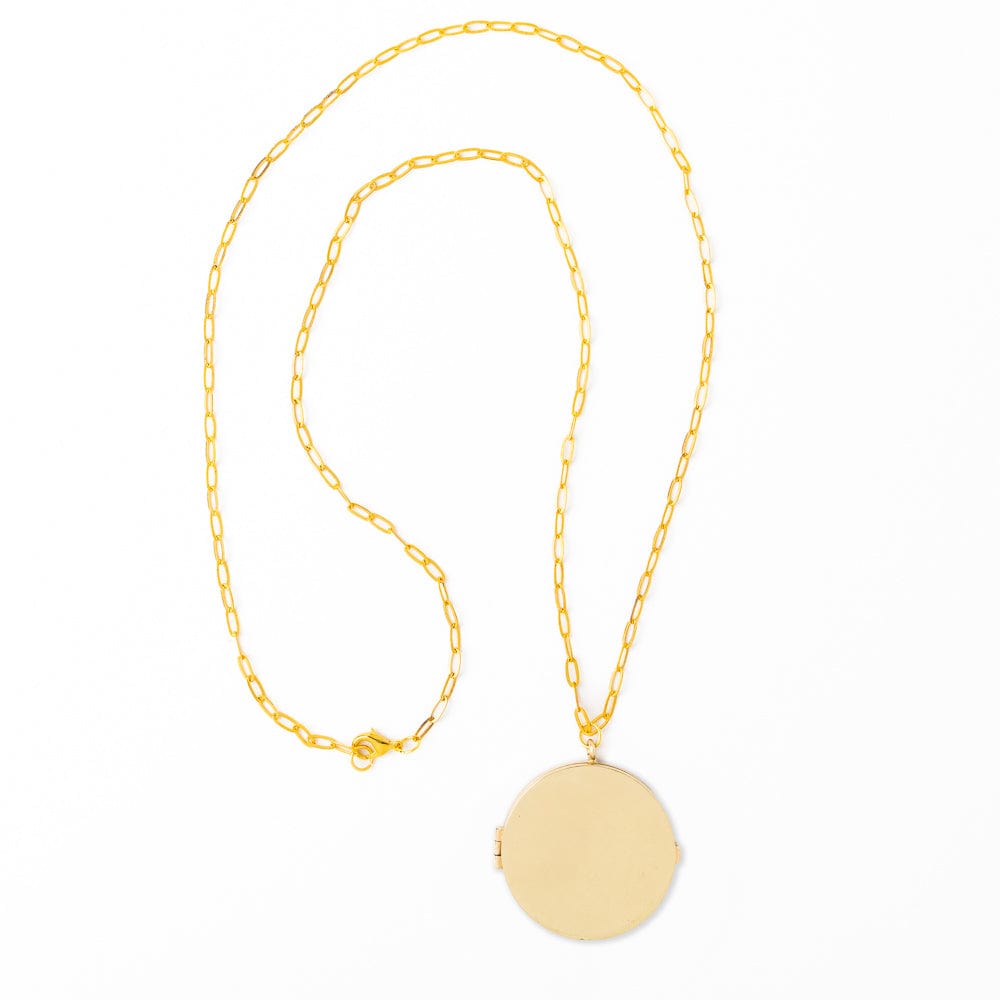Gold necklace with a round locket on a white background