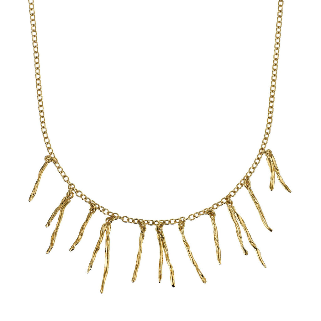 Gold necklace with pine needle pendants on a white background