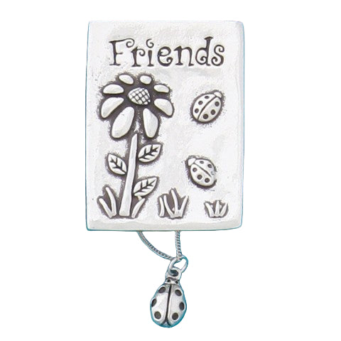 A pewter Friends Wish Box with a floral design and a small ladybug necklace attached to it.