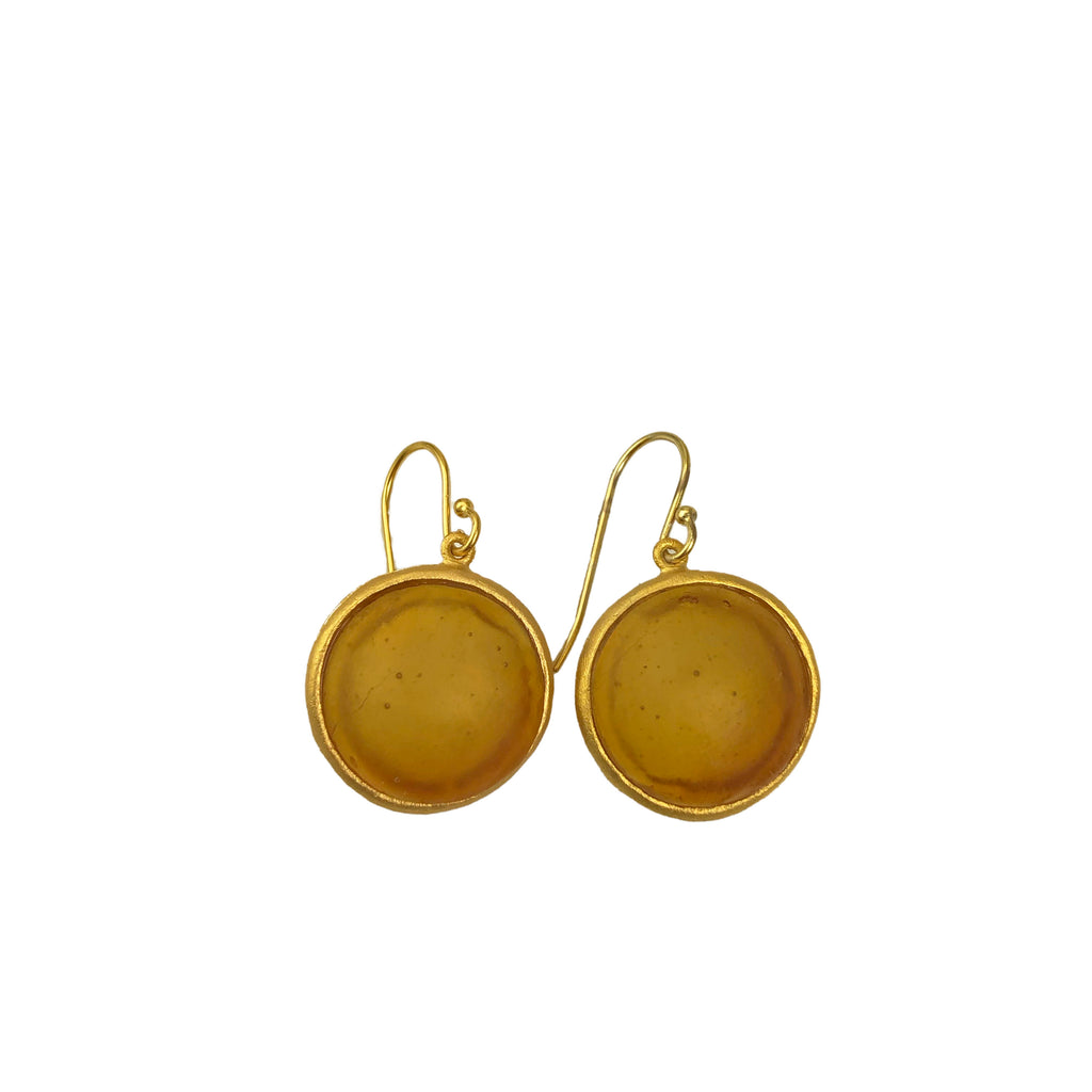 A pair of gold-colored wire earrings with amber glass charms, displayed against a white background.