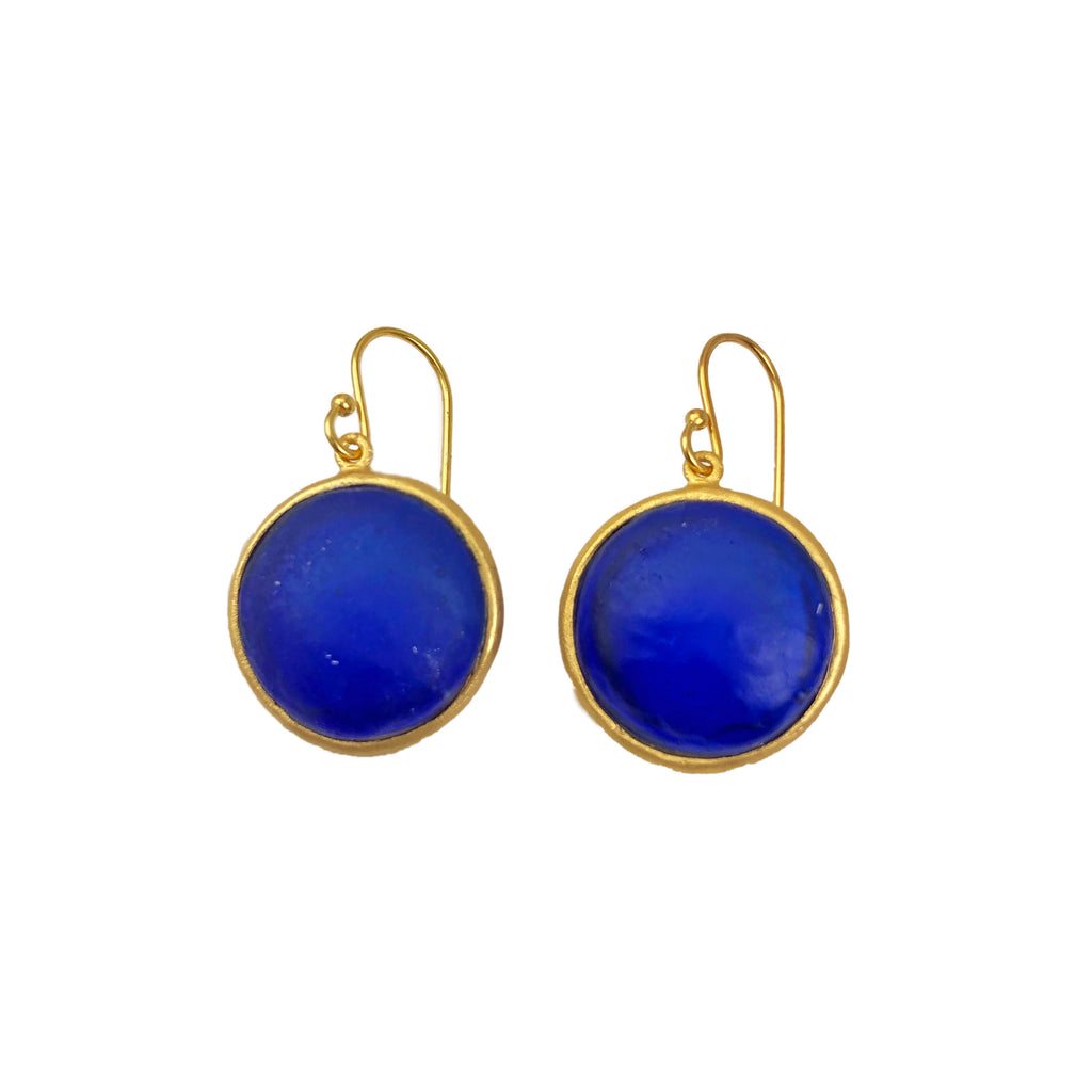A pair of gold-colored wire earrings with blue glass charms, displayed against a white background.