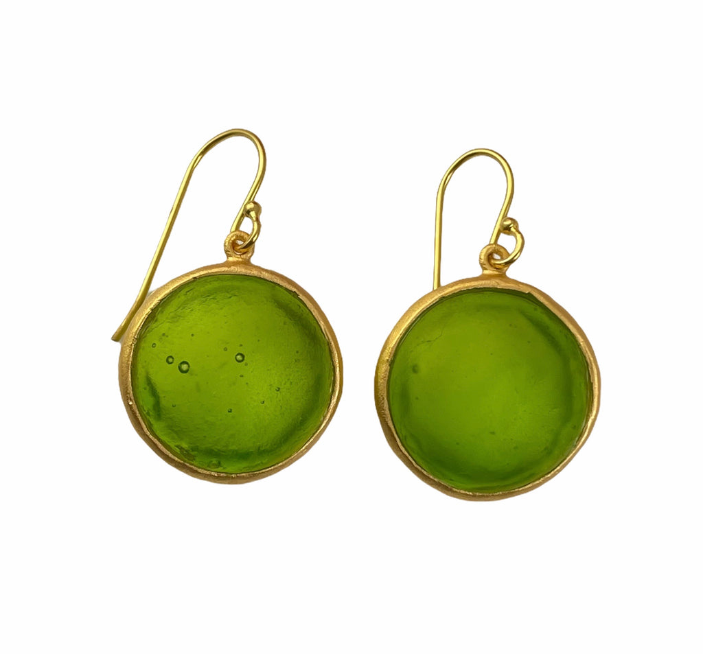 A pair of gold-colored wire earrings with blue glass charms, displayed against a white background.