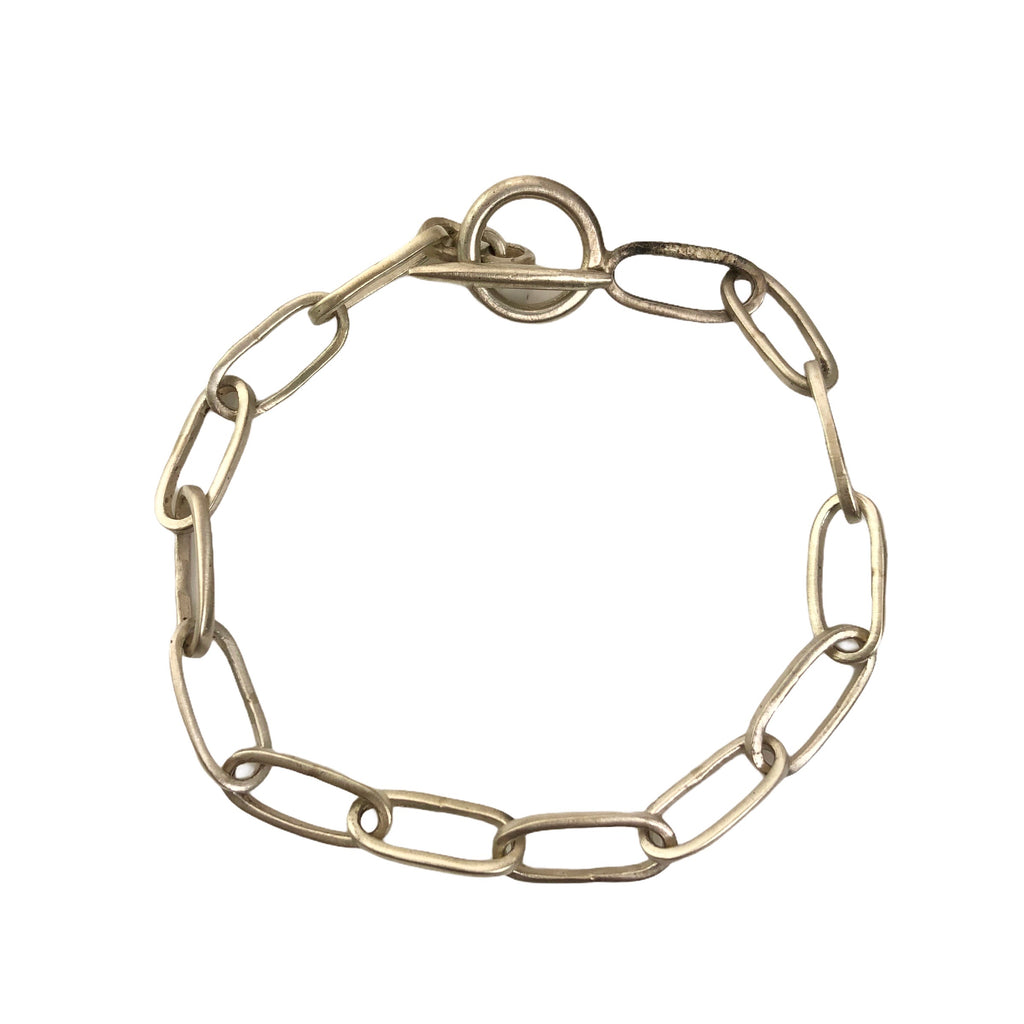 A long oval link chain bracelet made of antiqued sterling silver with a toggle clasp closure.