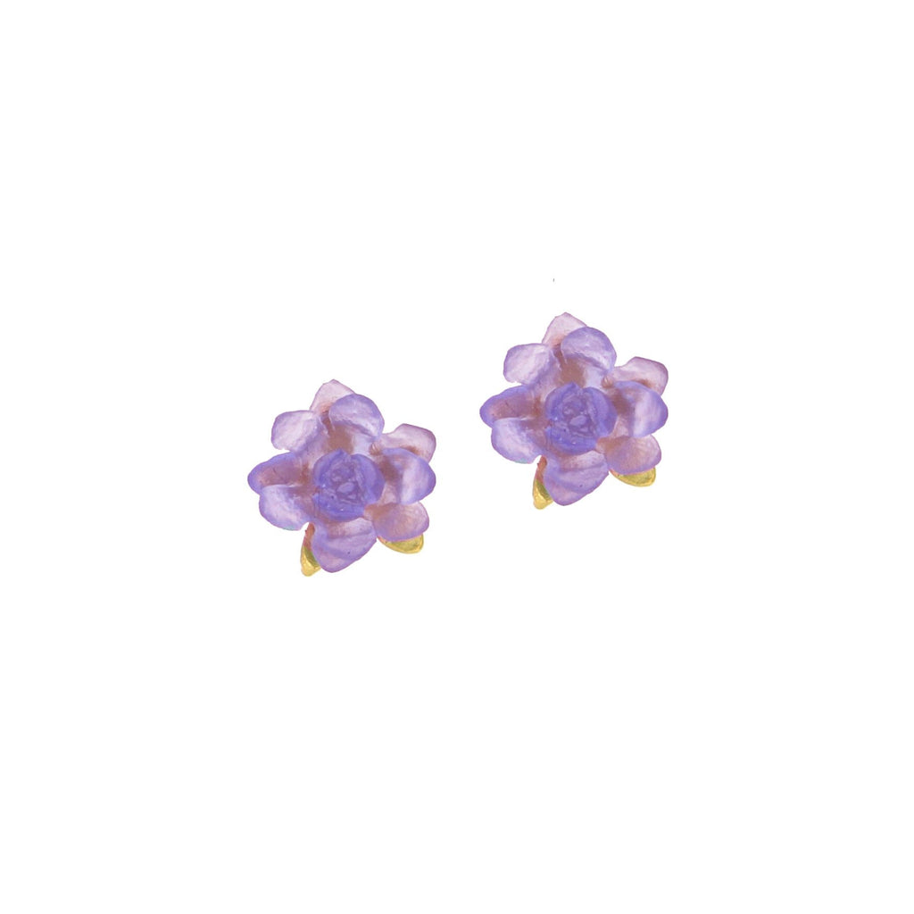 A pair of post earrings designed to resemble water lilies, with purple glass petals and a gold stem, on a white background