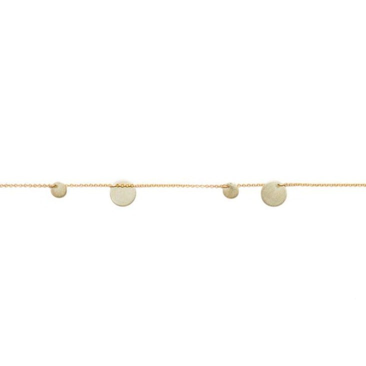 A bracelet with gold chain and silver discs, displayed against a white background.